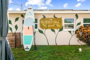 a sign on the side of a house with a surfboard at The Beverley Pool Hot Tub Near Clearwater Beach in Clearwater