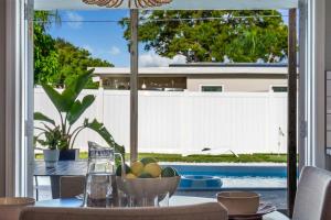a table with a bowl of fruit on top of it at The Beverley Pool Hot Tub Near Clearwater Beach in Clearwater +59 photos