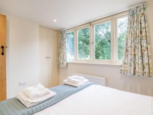 a bedroom with a bed with two towels on it at 2 Bed in Bristol 72582 in Winford