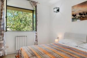 a bedroom with a bed and a large window at Residence Brughiera Malpensa in Lonate Pozzolo