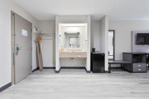 a bathroom with a sink and a mirror at Quality Inn Edmund Pettus Bridge area in Selma +23 photos