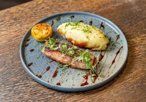 a plate with two pieces of food on a table at The Catalyst Apartment Hotel by NEWMARK in Johannesburg