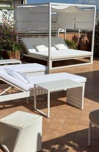 deux lits blancs et un banc sur une terrasse dans l'établissement The Rooftop Terrace b&b Double Rooms Private Bathrooms and an equipped Roof Terrace, à Sant'Agnello 51 autres photos