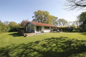 a small house in a field with a yard at 30312-Odder-Lyngbakkevej-29 in Odder