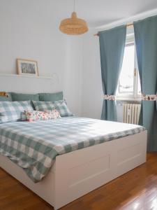 a bedroom with a bed with blue curtains at Lovely Flat in Morgex in Morgex
