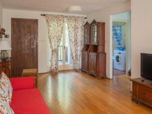 a living room with a couch and a tv at Lovely Flat in Morgex in Morgex