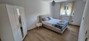 a small bedroom with a bed and a window at Marin&Mark Stay in Zagreb