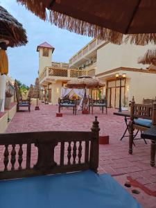 a courtyard with benches and umbrellas in a building at The Swahili Plaza in Matemwe