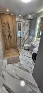 a bathroom with a shower and a toilet at Marin&Mark Stay in Zagreb