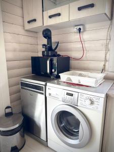 a washing machine with a camera on top of it at Cabana Zouk in Poiana Aiudului