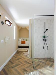 a shower with a glass door in a bathroom at Domeniile Clos des Colombes in Douăzeci şi Trei August +24 photos