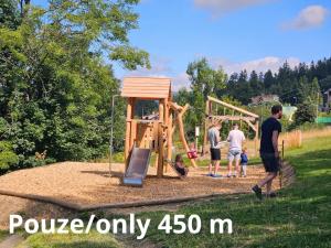 a group of people standing around a playground at Benecko s možností wellness - A30 by AlkaTravel in Benecko