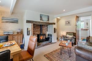 a living room with a fireplace and a table at Church View in Heacham
