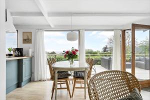 a kitchen and dining room with a table and chairs at 30725-Odder-Skovgardsparken-87 in Odder +20 photos