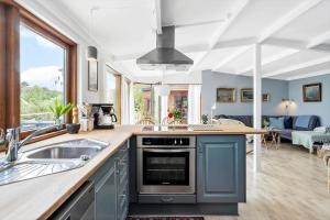 a kitchen with a sink and a stove top oven at 30725-Odder-Skovgardsparken-87 in Odder