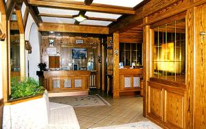 a large room with wooden walls and a lobby at Hotel Gran Mugon in Vigo di Fassa