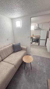 a living room with a couch and a table at Nisay Home - Apart Hotel - 3 Room Apartment - N3 in Ludwigsburg