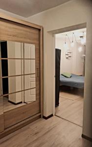 a room with a door leading to a bedroom at Cozy 2-Bedroom flat with Terrace & Parking by Alfa in Rīga