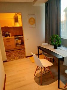 a kitchen and dining room with a table and chairs at Cozy 2-Bedroom flat with Terrace & Parking by Alfa in Rīga +41 photos
