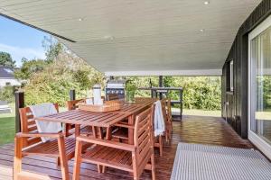 a wooden table and chairs on a deck at 30027-Malling-Peter-Eriksens-Vej-14 in Malling