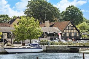 a boat in the water in front of a building at 30144-Kysing-Naes-Odder-Naesvej-44 in Norsminde