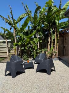 a group of four black chairs sitting on the ground at Maison entièrement rénovée in Dinard