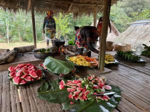 a group of people preparing food on a wooden table at Casa Fofo in San Carlos