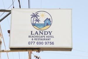 Un cartel que anuncia un hotel y restaurante junto a la playa. en Landy Beachscape Hotel & Restaurant, en Negombo