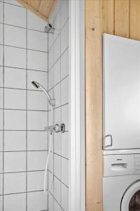a shower in a bathroom with a washing machine at 30522-Odder-Engagervej-89 in Odder +20 photos