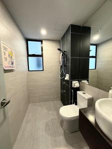 a bathroom with a toilet and a sink at Malacca Town TrendCove Homestay in Melaka