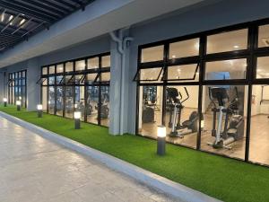 a gym with a row of windows with exercise equipment at Malacca Town TrendCove Homestay in Melaka