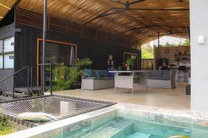 a house with a swimming pool and a patio at Al Caribe Sur in Puerto Viejo