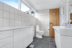 a white bathroom with a toilet and a sink at 30582-Odder-Dyngby-Havvej-66 in Odder +38 photos