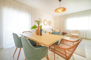 a dining room with a wooden table and chairs at Surf Spot by Moje Holiday in Portimão +9 photos