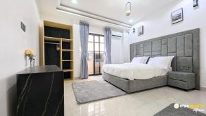 a bedroom with a large bed in a room at Chic studio with parking and rooftop in Yaoundé +16 photos