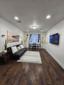 a living room with a couch and a table at Spacious 2BR Apt| 3 Beds | 15 Min to NYC in North Bergen