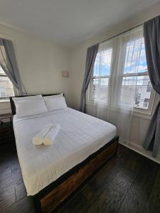 a bedroom with a bed with two towels on it at Spacious 2BR Apt| 3 Beds | 15 Min to NYC in North Bergen