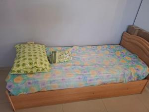 a bed with two pillows on top of it at Centre studio 16 in Netanya