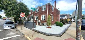 a stop sign in front of a red brick house at Spacious 2BR Apt| 3 Beds | 15 Min to NYC in North Bergen