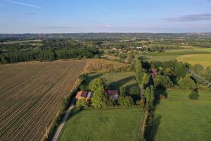 an aerial view of a house in a field at Gîte les Millères - Le Duplex Cosy in Villemur-sur-Tarn