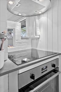 a kitchen with a sink and a counter top at 40526-Juelsminde-Pot-Strandby-53 in Sønderby