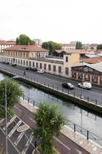 a view of a city with a river and a street at Vivace Bilocale con vista sul Naviglio -Mirable PM in Milan +18 photos