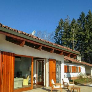 a house with sliding glass doors and a patio at Villa With Pool Overlooking Lake Maggiore in Gignese