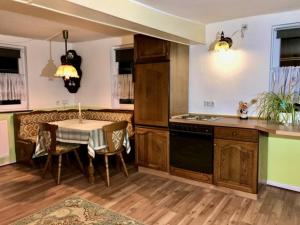 a kitchen with a table and a dining room at Aparthotel Villa Reimold in Bebra