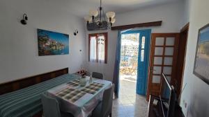 a bedroom with a table and a room with a door at Comfort and unparalleled view in Kóronos
