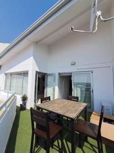 a table and chairs on a patio with a roof at 270 Degree City View Serenity in Windhoek