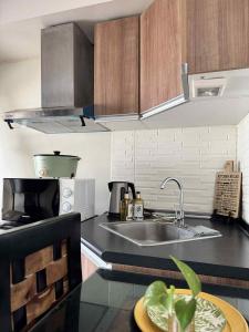 a kitchen with a sink and a counter top at Tagaytay Staycation with Great Location in Tagaytay