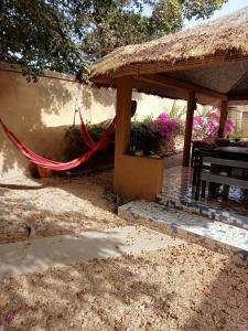 a hammock in the shade of a house at Chambre d'hôte Maryvonne & Mamadou in Nianing +9 photos