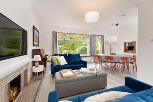 a living room with a blue couch and a fireplace at Lawhead Road East in St. Andrews