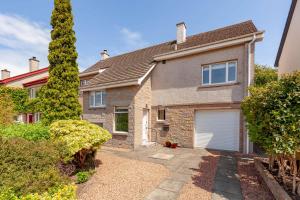 a brick house with a garage in front of it at Lawhead Road East in St. Andrews